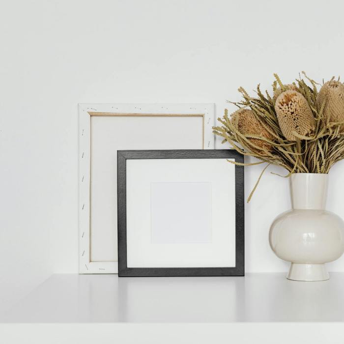 dried showy banksia flowers on white ceramic vase